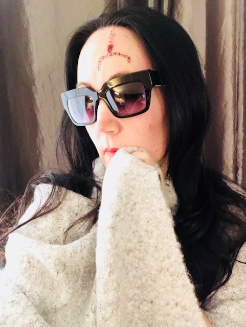 Client before treatment, with a basal cell carcinoma on her forehead
